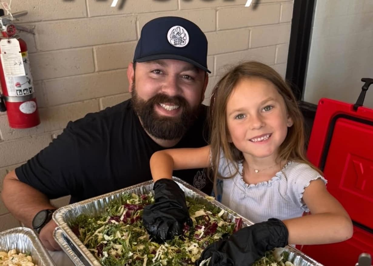 Michael Duarte cooking BBQ in his kitchen