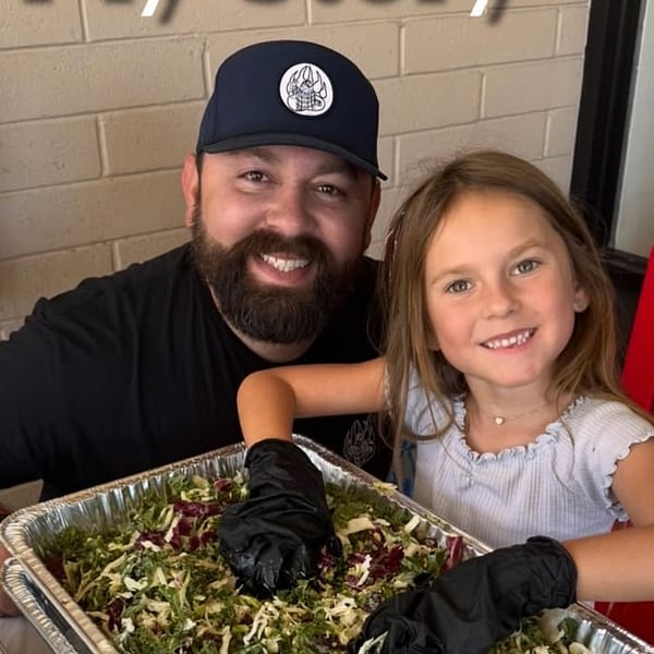 Michael Duarte cooking BBQ in his kitchen
